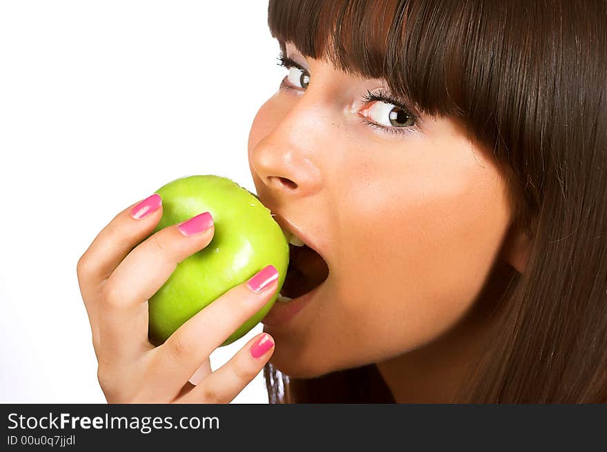 Close-up portrait of young girl eating green apple isolated on white background. Close-up portrait of young girl eating green apple isolated on white background