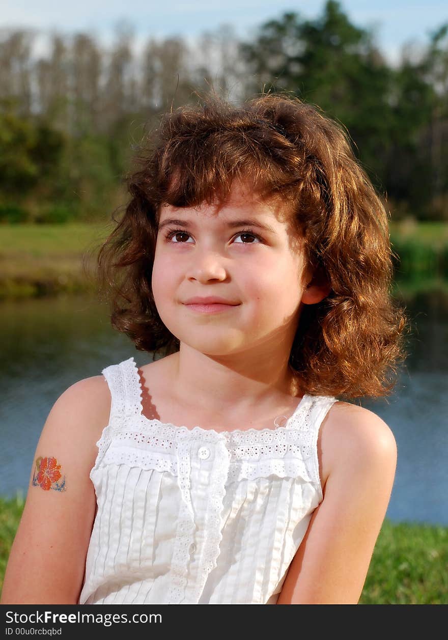 The close up of a cute girl with brown eyes and curly hair. The close up of a cute girl with brown eyes and curly hair