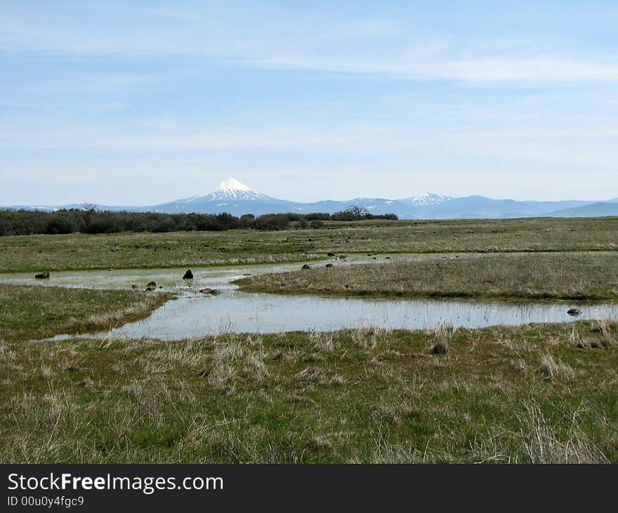 Mt McLaughlin seen across a small water flow on top of Table rock in the Rouge valley.  Oregon, U.S.A.