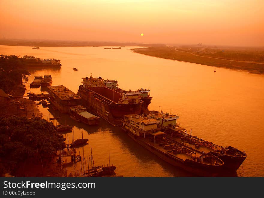 A small inland river city port in the sunrise, a port at the converging place of two rivulet Foshan,guangdong,China. A small inland river city port in the sunrise, a port at the converging place of two rivulet Foshan,guangdong,China.