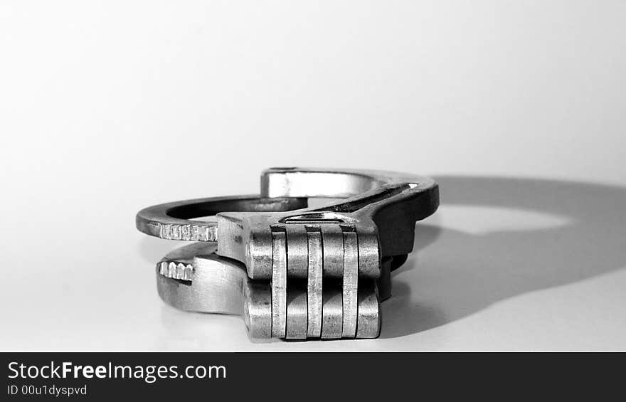 Handcuffs on white background with shadow