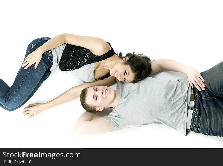 A young couple in love lying down together in a studio