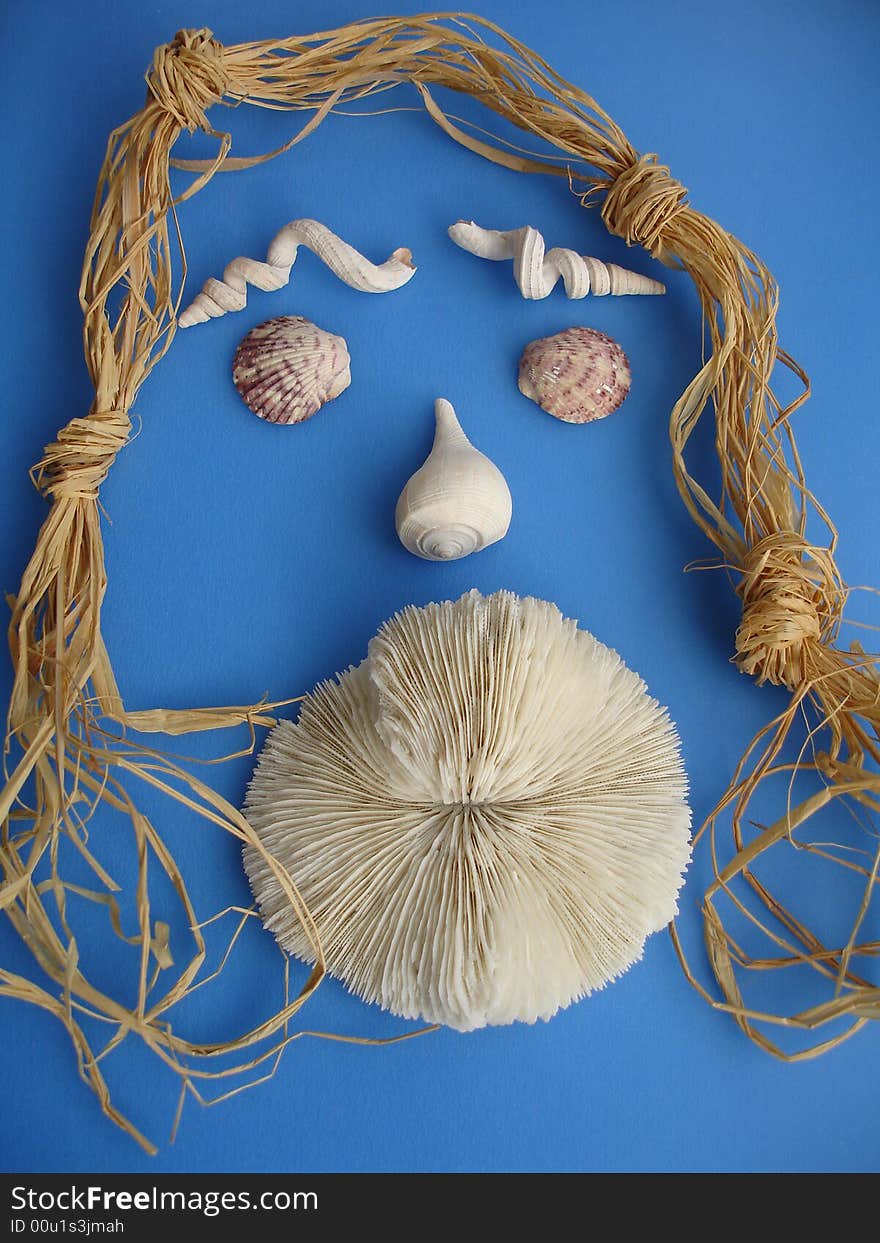 Seashells and a solitary mushroom coral arranged like a face of a woman with big lips and straw hairs, on blue background. Seashells and a solitary mushroom coral arranged like a face of a woman with big lips and straw hairs, on blue background