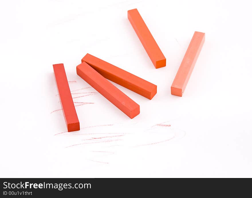 Red and orange square pastel crayons on white background. Red and orange square pastel crayons on white background