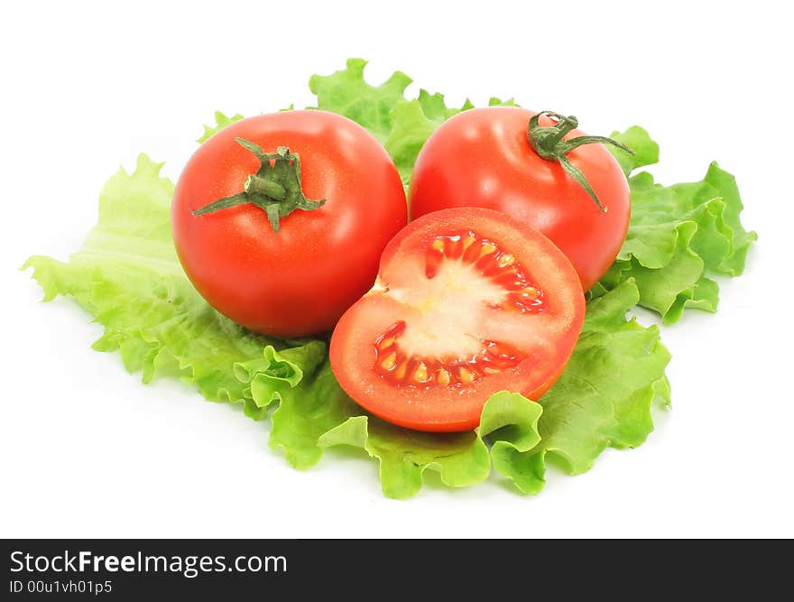 Fresh tomatoes with cut on sheet of salad