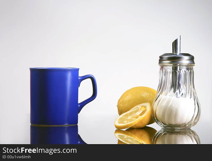 A blue cup of tea with lemons and sugar. A blue cup of tea with lemons and sugar