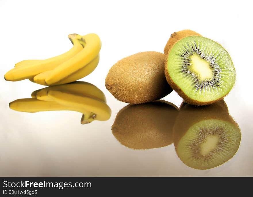 Bananas and kiwis standing on the white. Bananas and kiwis standing on the white