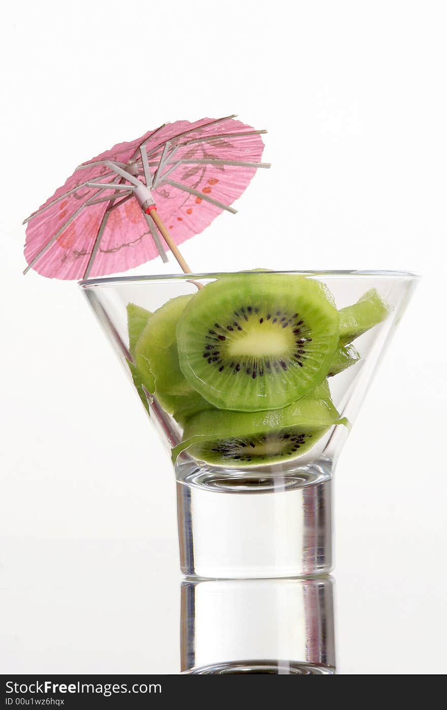 Kiwi is standing in a cup with pink umbrella detail. Kiwi is standing in a cup with pink umbrella detail