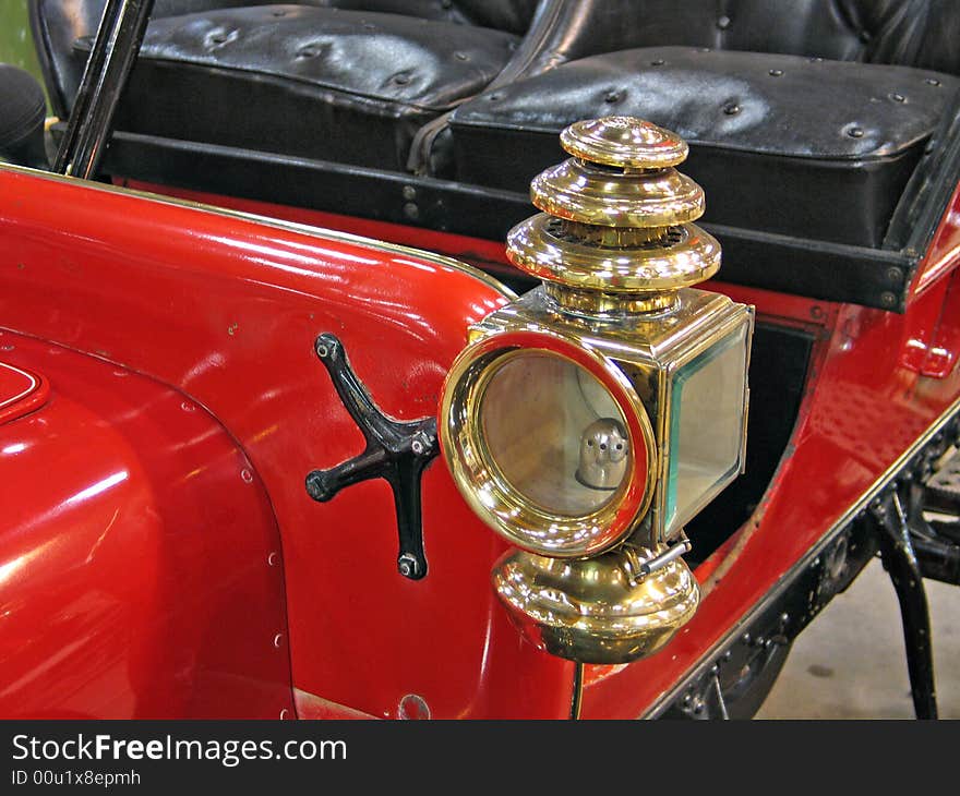 Details of a beautiful red antique car brass lamp. Details of a beautiful red antique car brass lamp