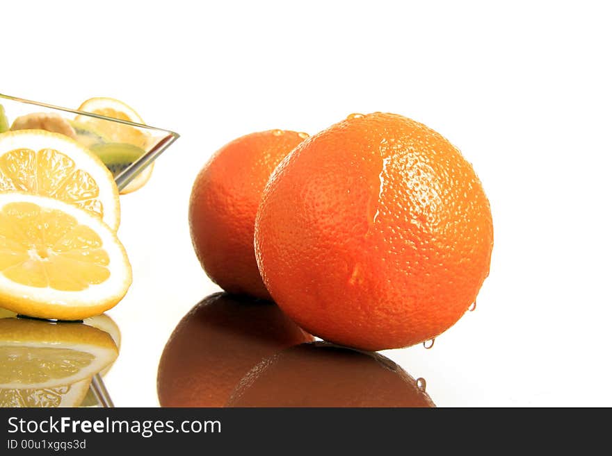 Two oranges with lemon standing together