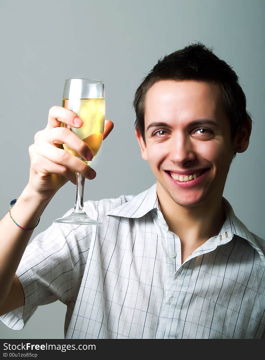 Young man drinking champaign and smiling