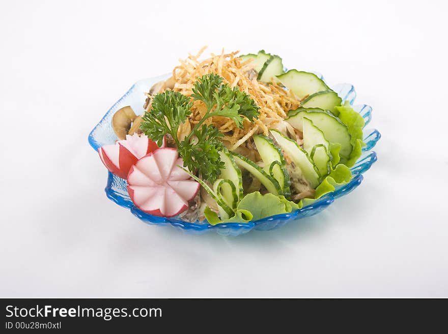 Mushrooms and veggies salad on a blue transparent shell shaped plate. Mushrooms and veggies salad on a blue transparent shell shaped plate.