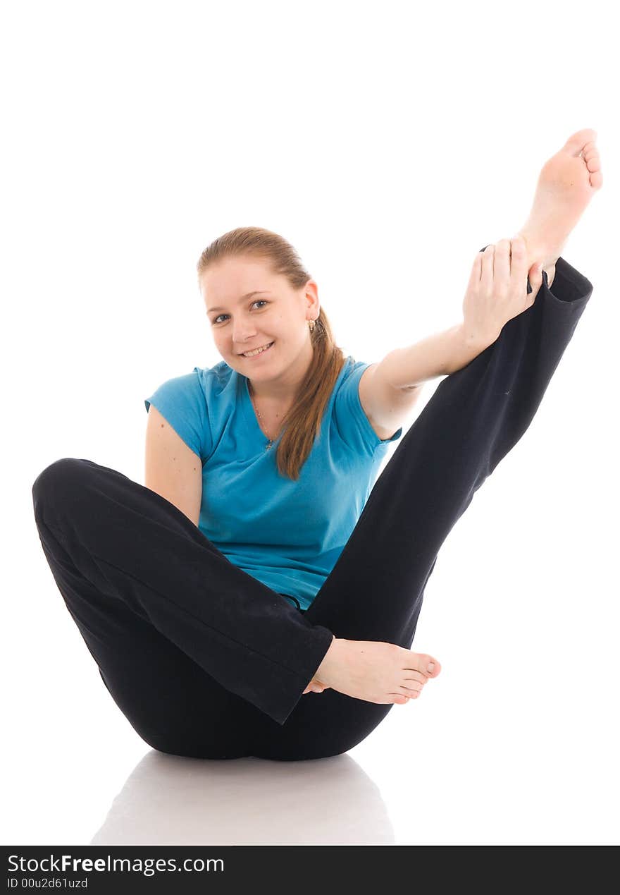 The beautiful young woman doing yoga exercise isolated on a white background. The beautiful young woman doing yoga exercise isolated on a white background