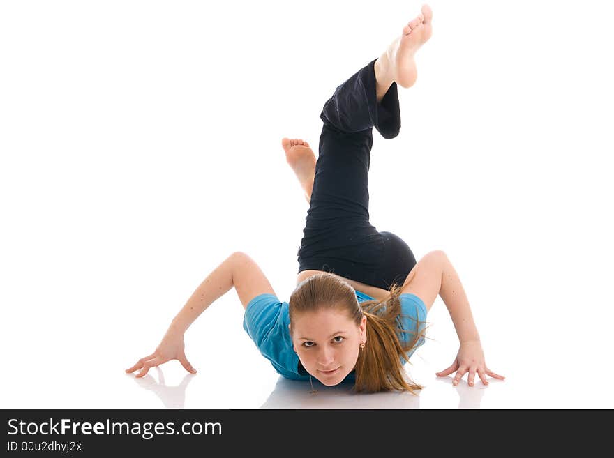 The beautiful young woman doing yoga exercise isolated on a white background. The beautiful young woman doing yoga exercise isolated on a white background