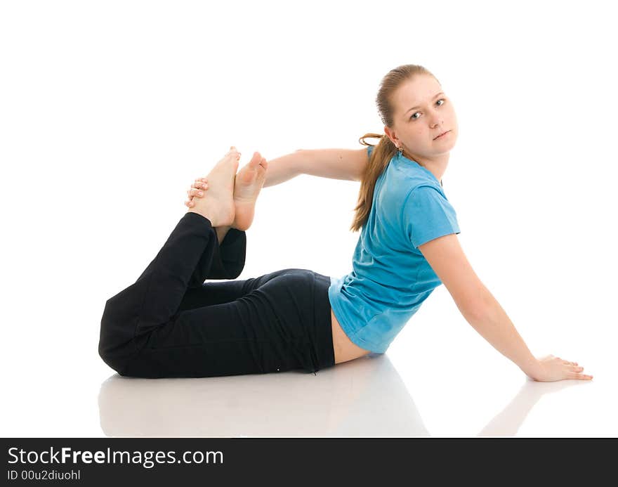 The beautiful young woman doing yoga exercise isolated on a white background. The beautiful young woman doing yoga exercise isolated on a white background