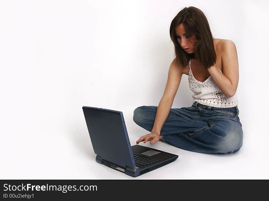 Brunette girl with laptop on white background