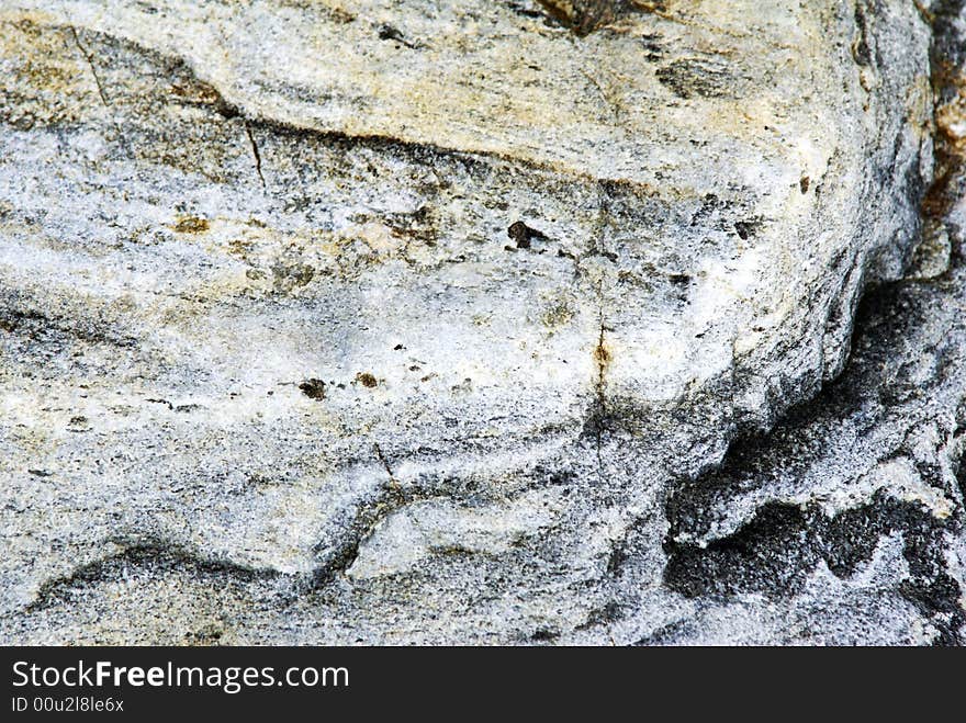 A curved rock texture that is gray colored