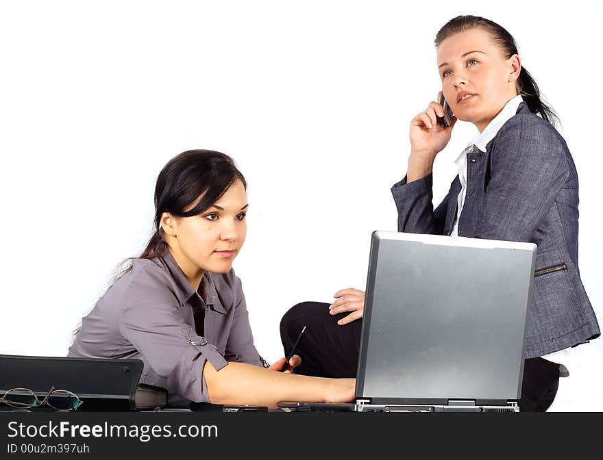 Two attractive brunette women working in office. Two attractive brunette women working in office