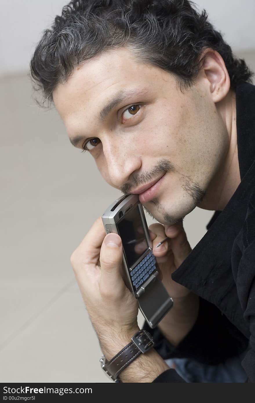 Romantic smiling man with smartphone