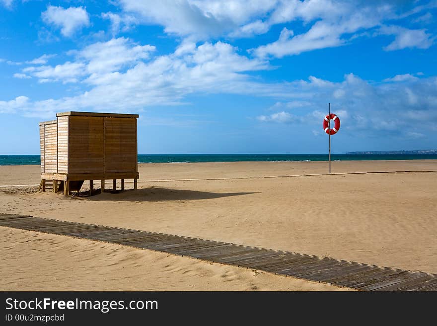 Deserted sandy beach under the dark blue sky with clouds. Deserted sandy beach under the dark blue sky with clouds