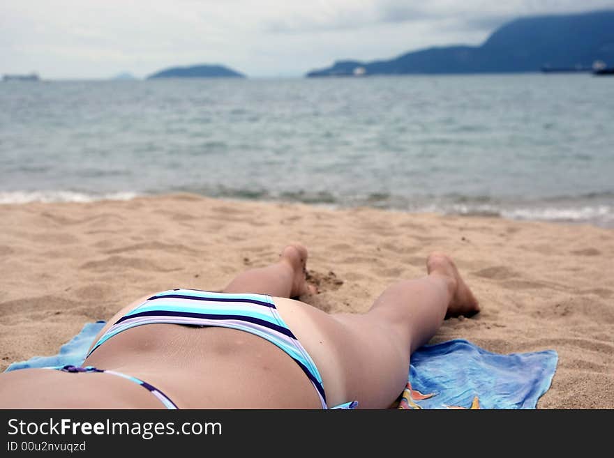 Sexy young woman relaxing on the beach