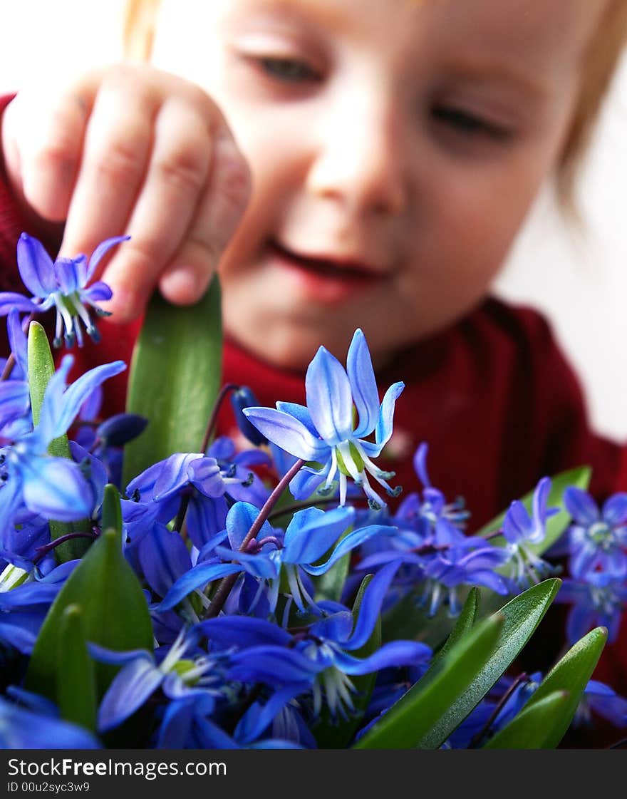 Little girl tries to keep a bouquet