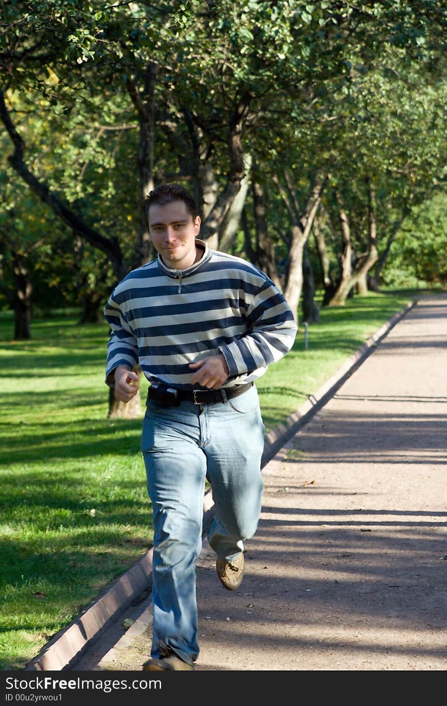 Man run by the road in the park. Man run by the road in the park