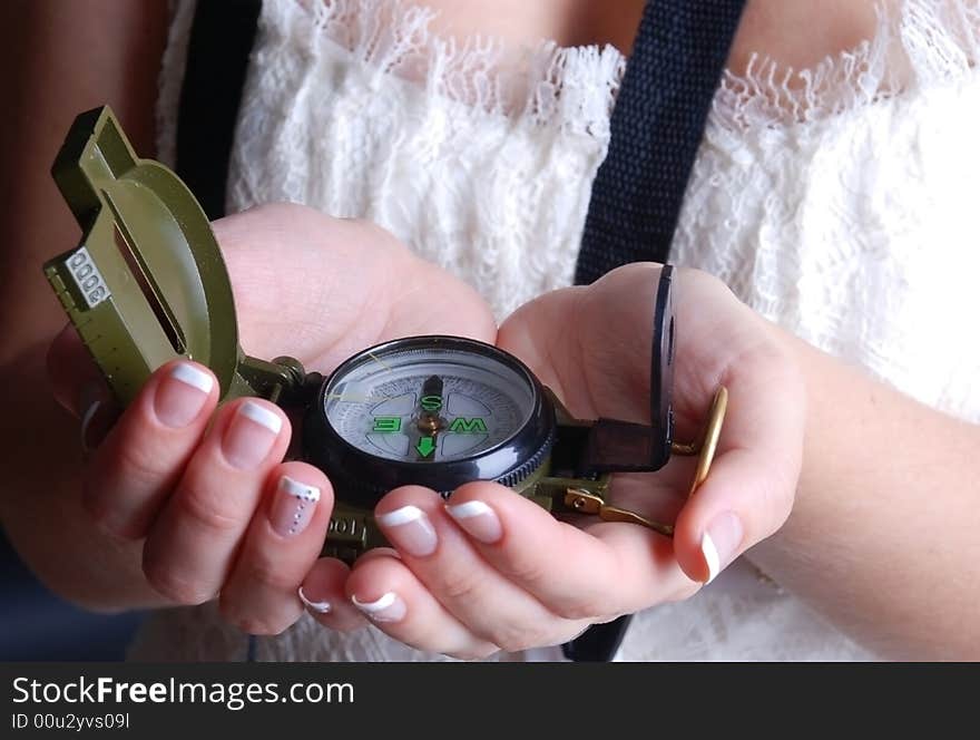 Woman takes a compass in hands