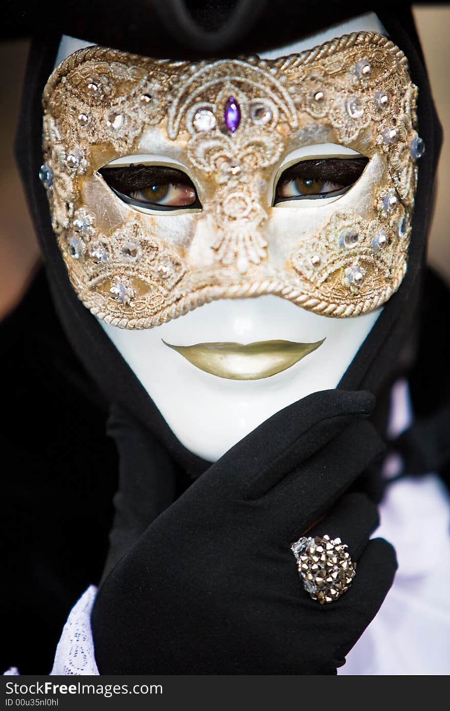 Venetian man in black costume with a golden mask. Venetian man in black costume with a golden mask