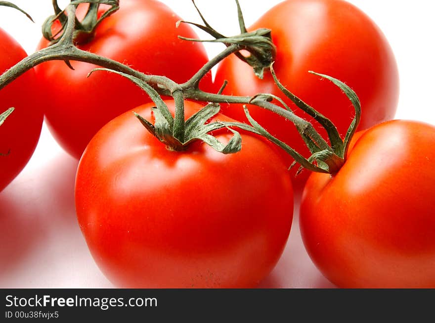 Red tomatos isolated on white