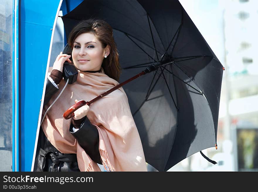 An image of young girl speaking on the telephone. An image of young girl speaking on the telephone