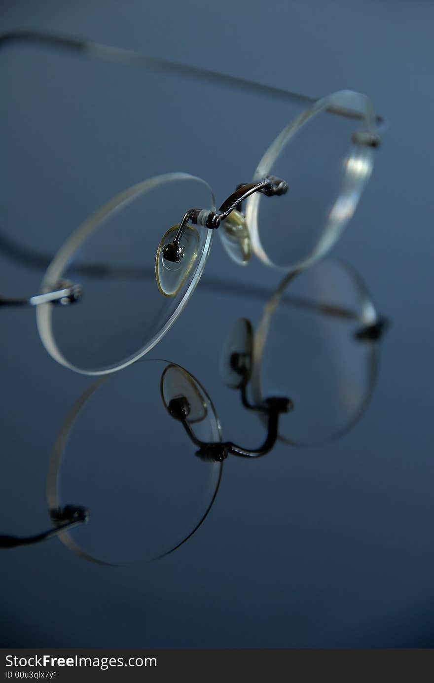 Spectacles without frames on glas. Spectacles without frames on glas