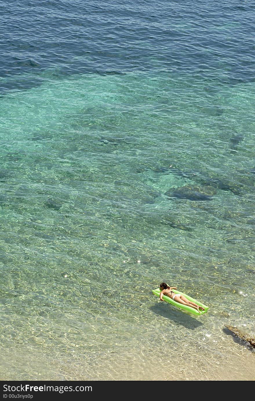 Relaxing on the tropical sea water surface on the vacation. Relaxing on the tropical sea water surface on the vacation