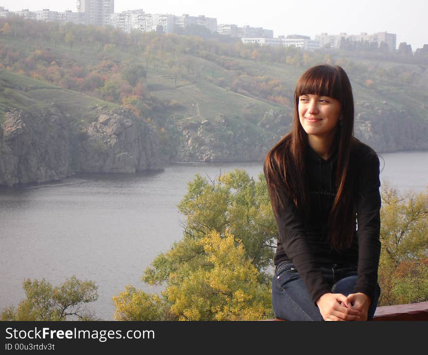 Girl dreaming about something near river bank. Girl dreaming about something near river bank