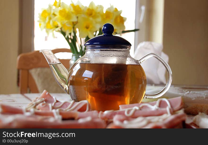 Glass Teapot on the table with sandwiches. Glass Teapot on the table with sandwiches