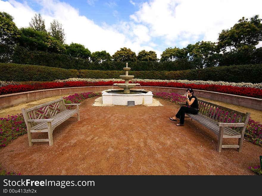 Young woman is having coffee break in beautiful garden. Young woman is having coffee break in beautiful garden