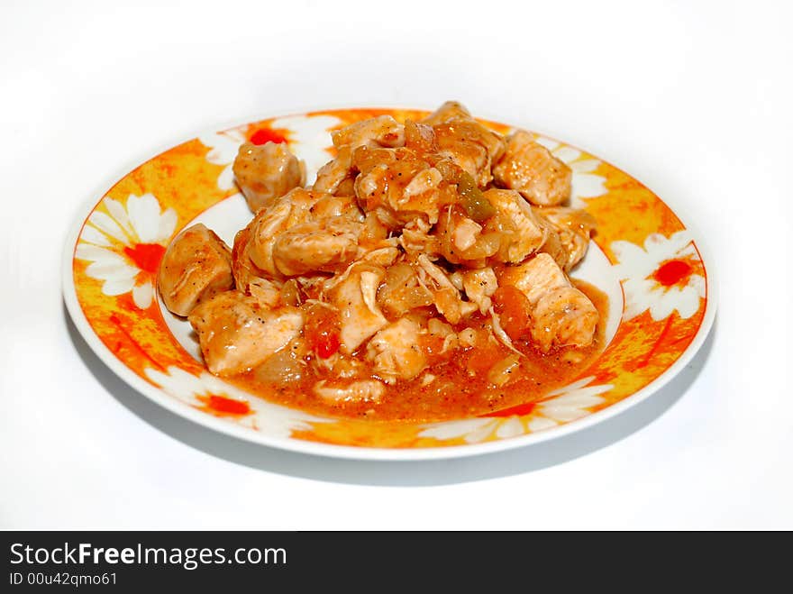 Meat pieces in orange piquant sauce on plate isolated over white. Meat pieces in orange piquant sauce on plate isolated over white