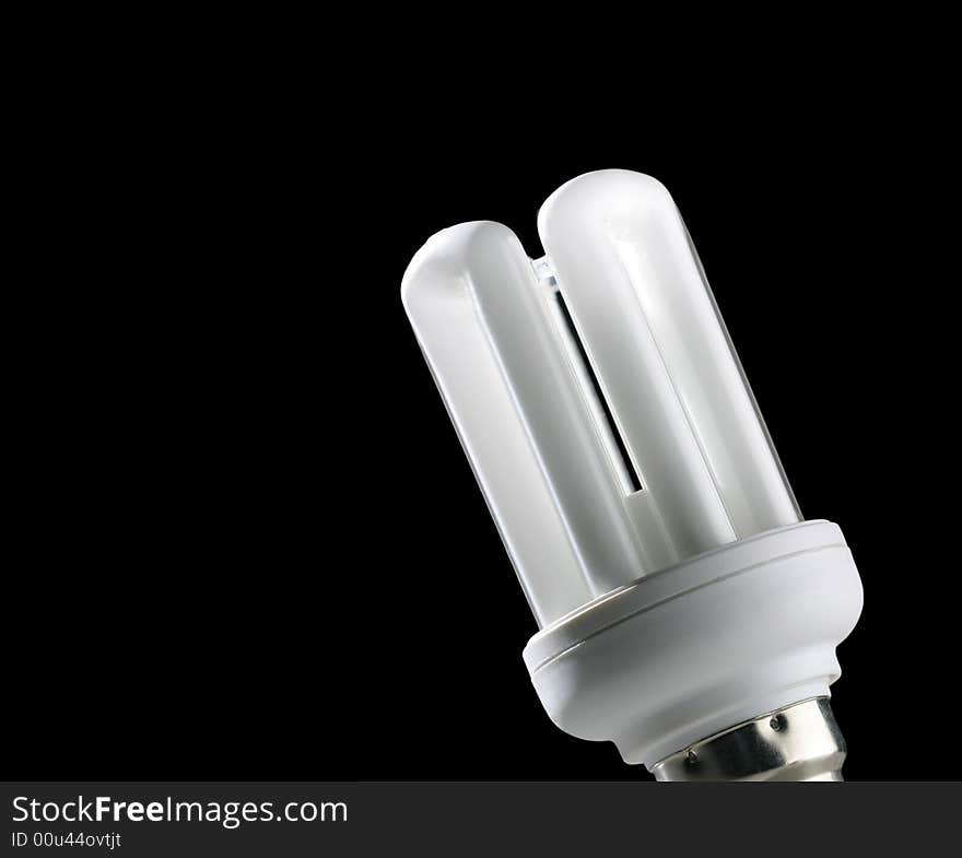 Close-up of low energy light bulb on black