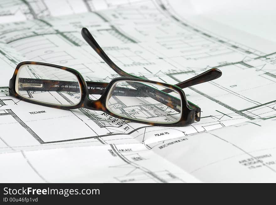 A big building plan with glasses