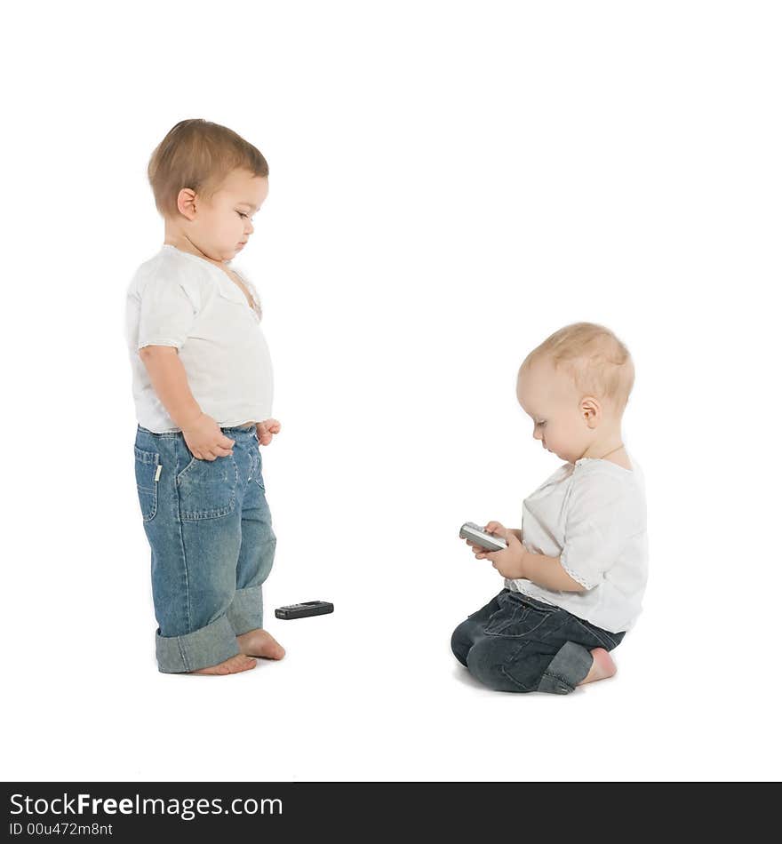 Two little boys with cellphones, white background. Two little boys with cellphones, white background