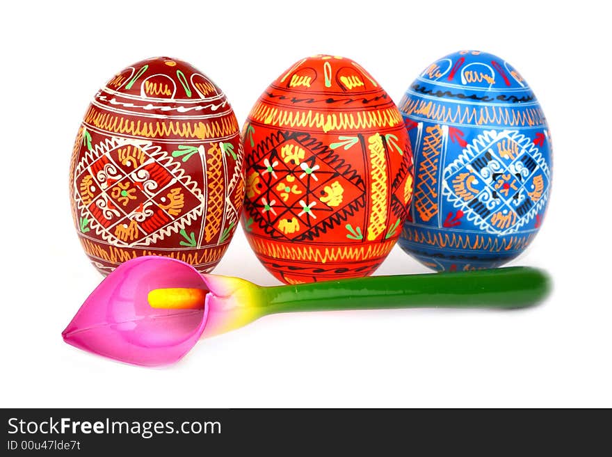 Three russian tradition easter eggs abreast and violet orchid over white