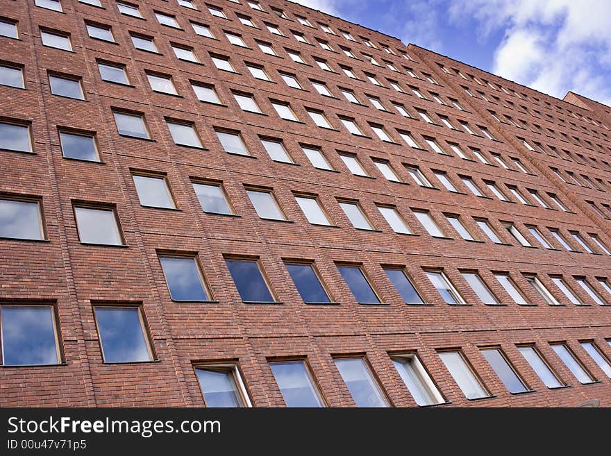 A picture of a red brick building and a nice blue sky. A picture of a red brick building and a nice blue sky