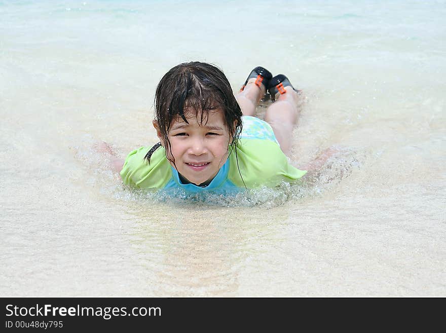 Girl plays in blue ocean water. Girl plays in blue ocean water