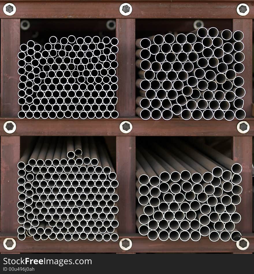 End view of circular pipes of various diameters on square cross sectional shelves. End view of circular pipes of various diameters on square cross sectional shelves