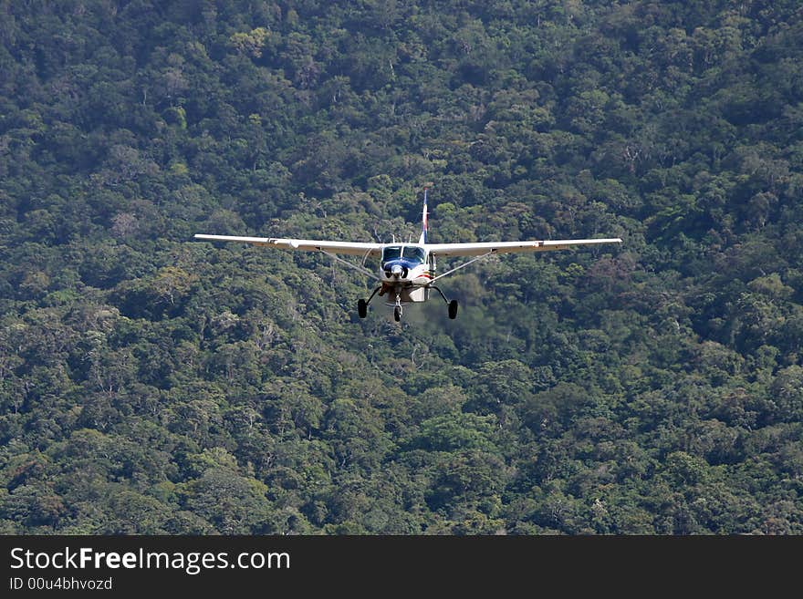 Plane flying over an isolated rainforest- exploration or exploitation?