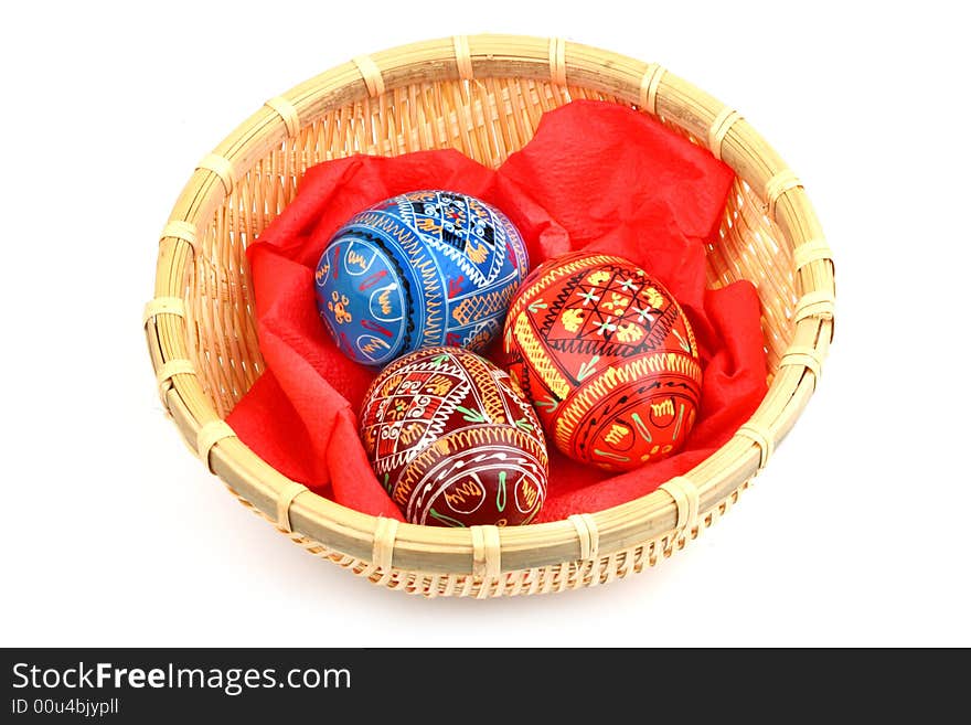 Three russian tradition easter eggs in yellow basket over white. Three russian tradition easter eggs in yellow basket over white