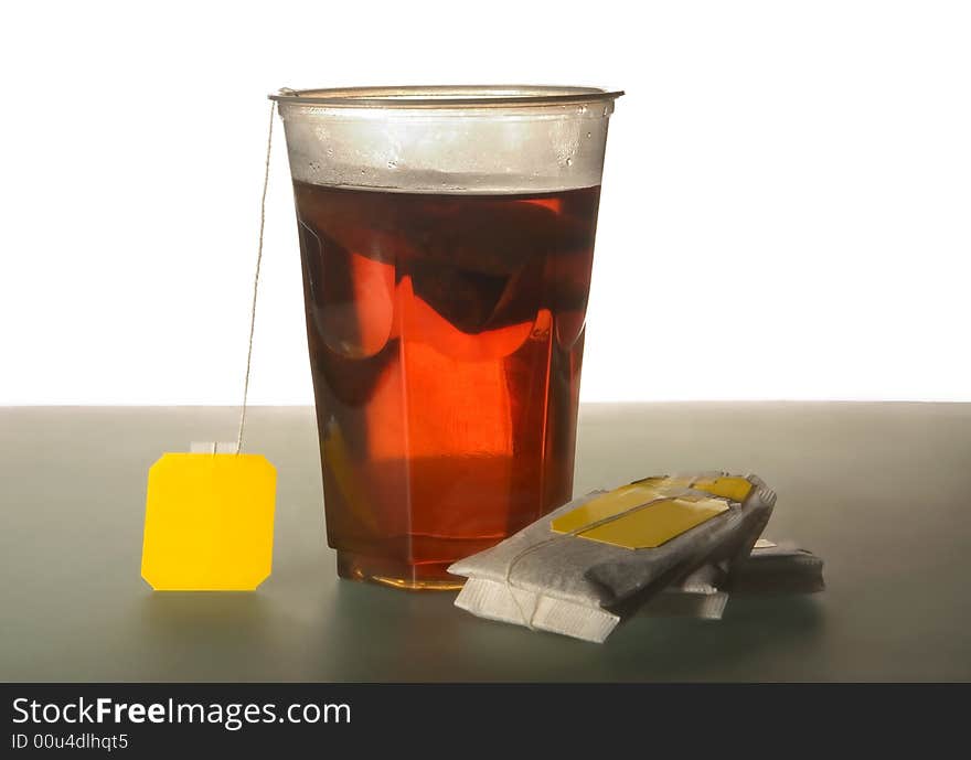 Tea bags and plastic glass with tea. Tea bags and plastic glass with tea