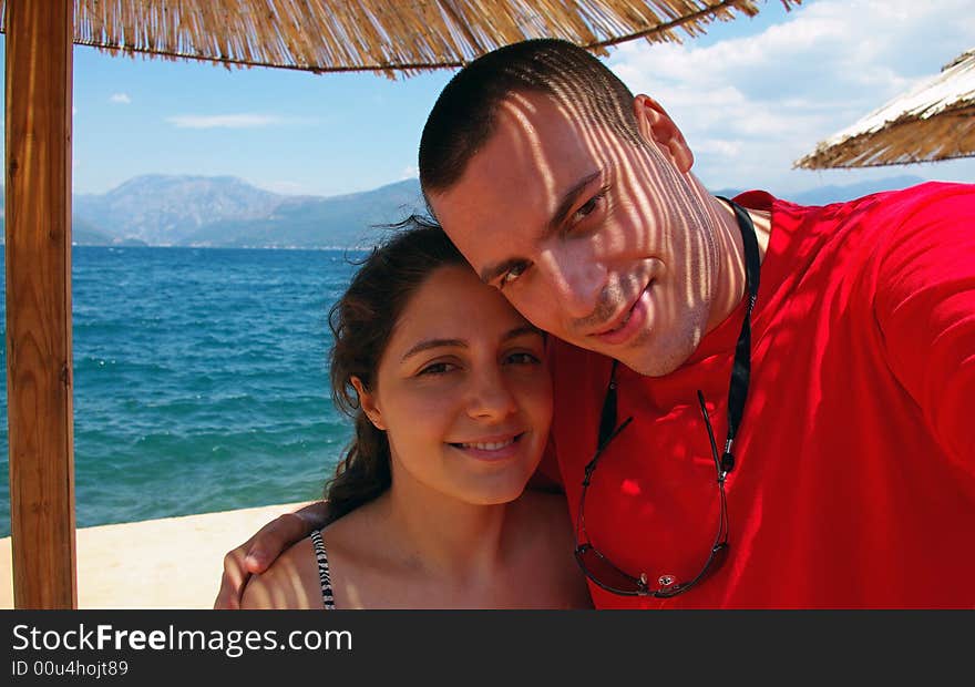 A couple, hugging on a mediterranean beach in Montenegro. A couple, hugging on a mediterranean beach in Montenegro