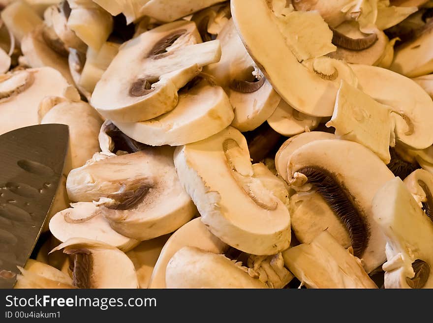 Cut up mushrooms wet and sliced on a cutting board