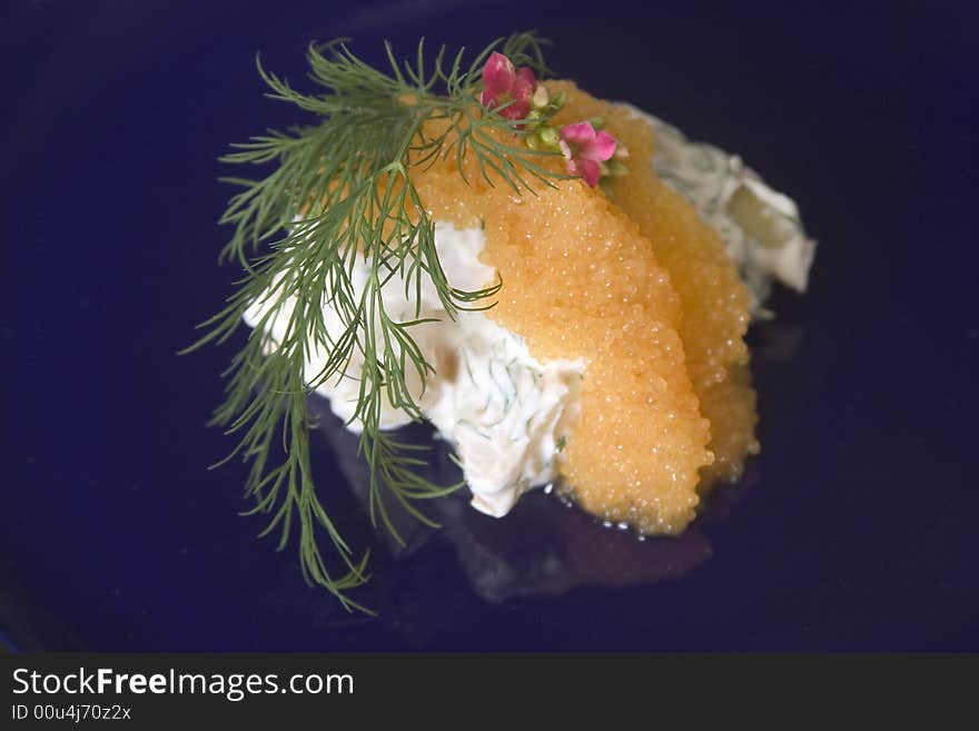 An appetizer of potato salad topped with caviar. An appetizer of potato salad topped with caviar.